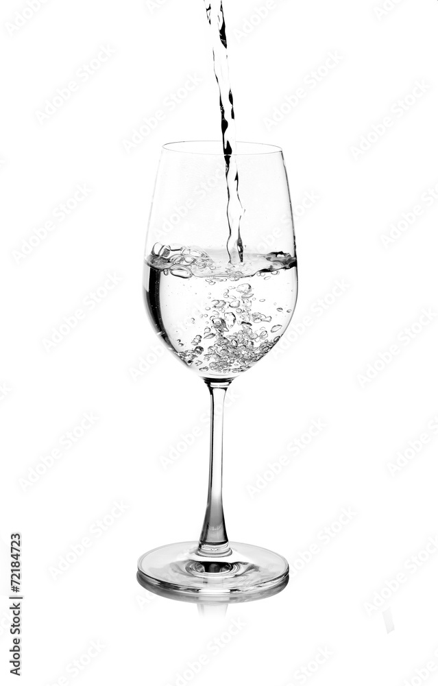 pouring water on a glass on white background pouring water on a glass on white background