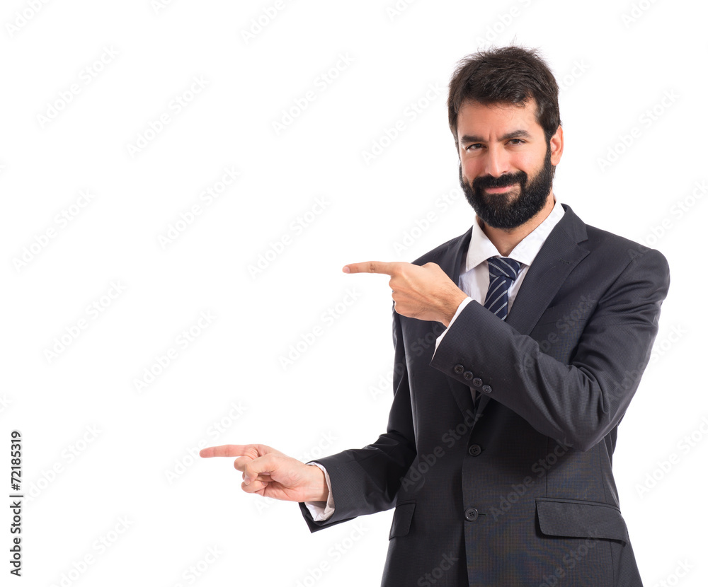 Businessman pointing to the lateral over white background Businessman pointing to the lateral over white background