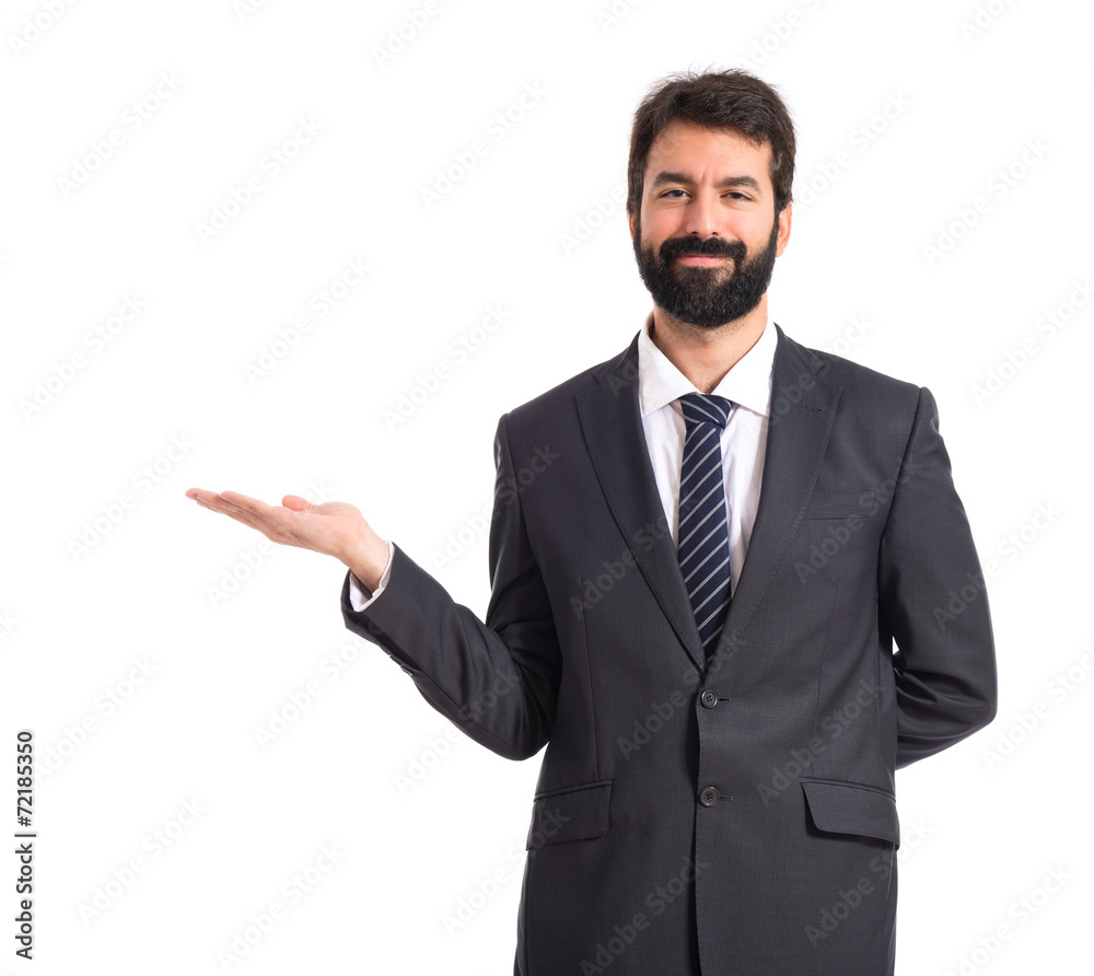 Businessman presenting something over isolated white background Businessman presenting something over isolated white background