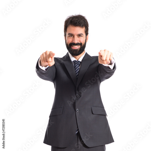 Businessman pointing to the front over white background