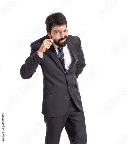 Businessman with magnifying glass over white background