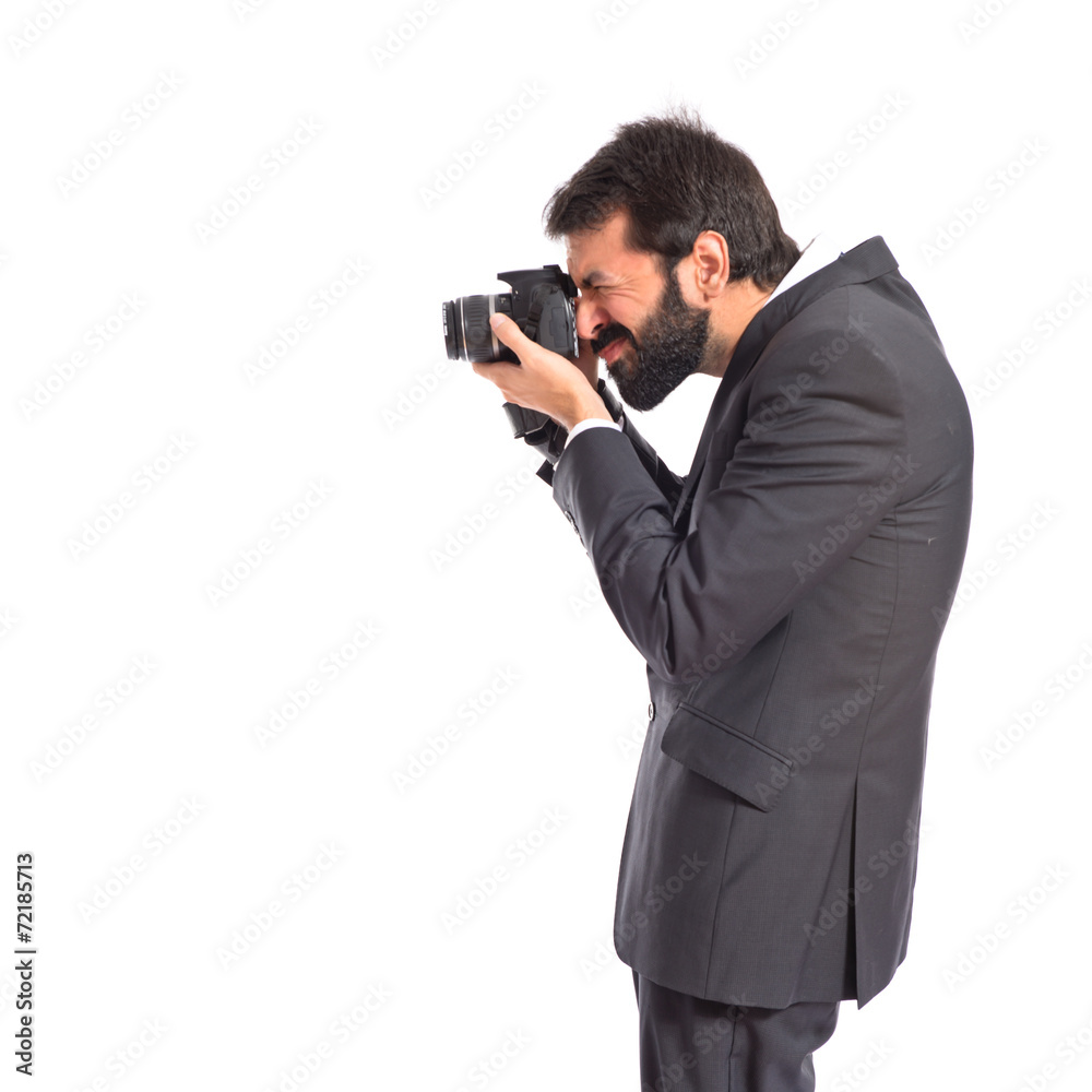 Businessman photographing over white background Businessman photographing over white background