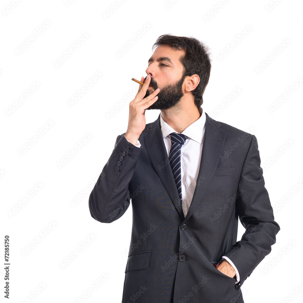 Businessman smoking over isolated white background Businessman smoking over isolated white background
