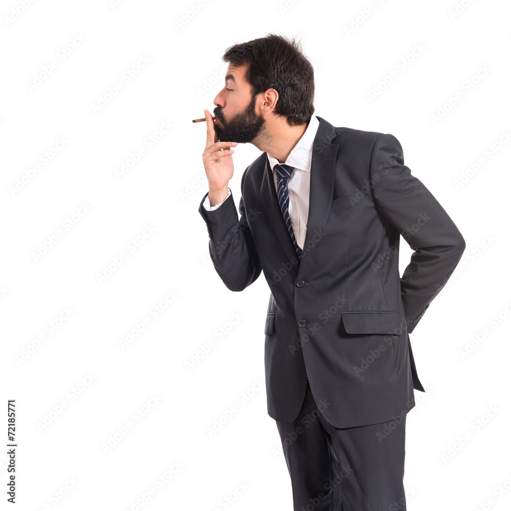 Businessman smoking over isolated white background Businessman smoking over isolated white background