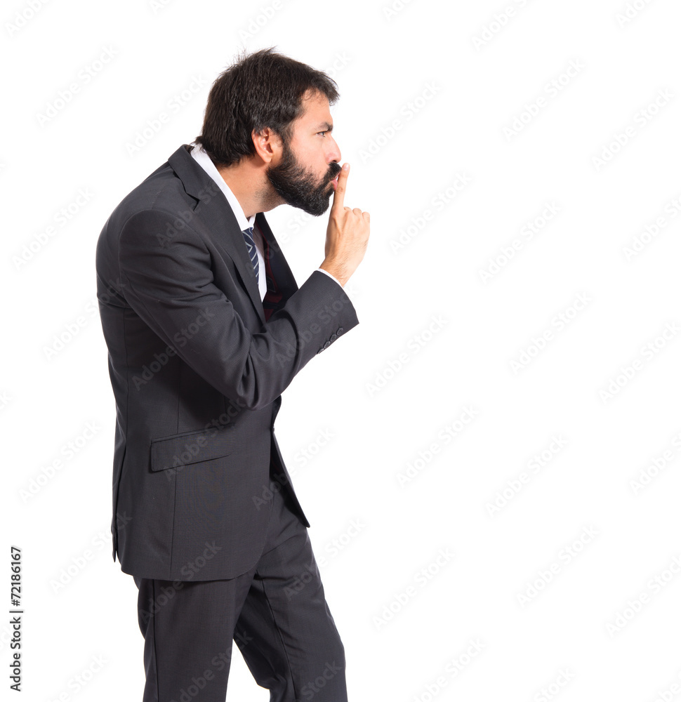 Businessman with costume making silence gesture Businessman with costume making silence gesture