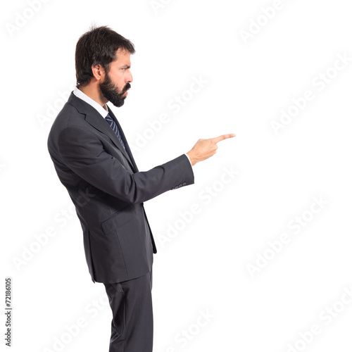Businessman pointing and shouting over isolated white background