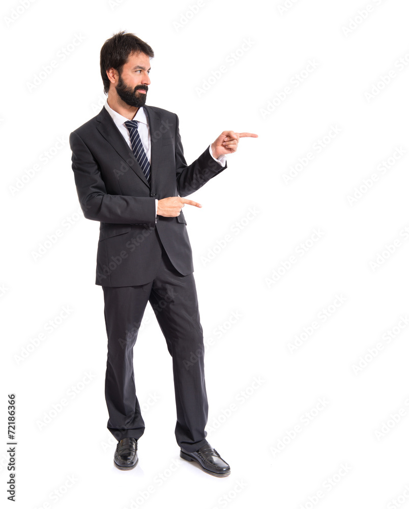 Businessman pointing to the lateral over white background Businessman pointing to the lateral over white background