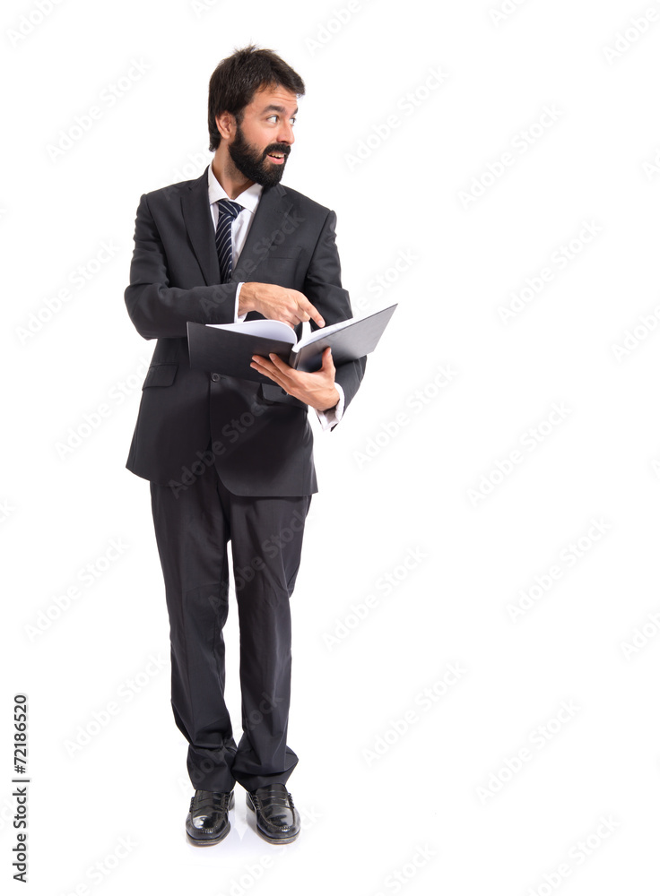 Businessman with book over white background Businessman with book over white background