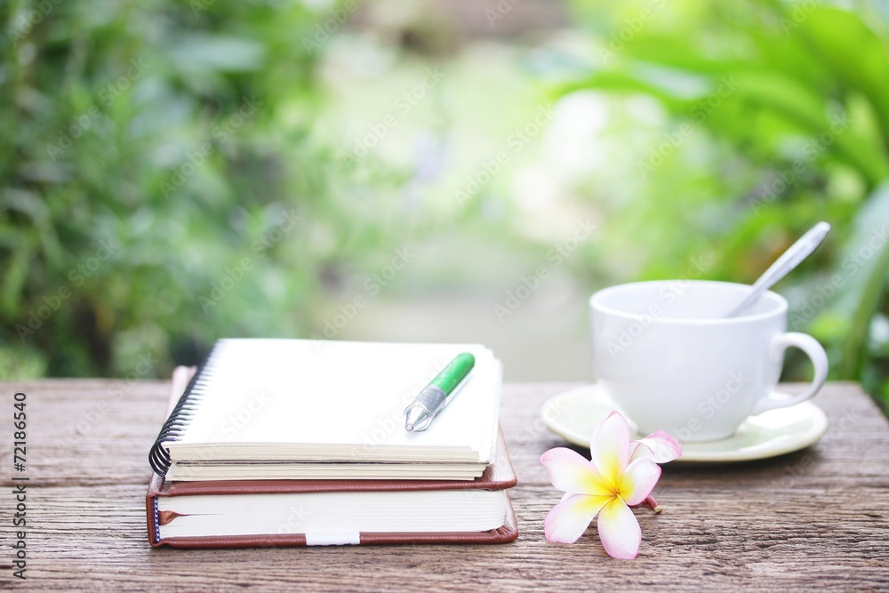 Notebook and coffee on wooden table Notebook and coffee on wooden table