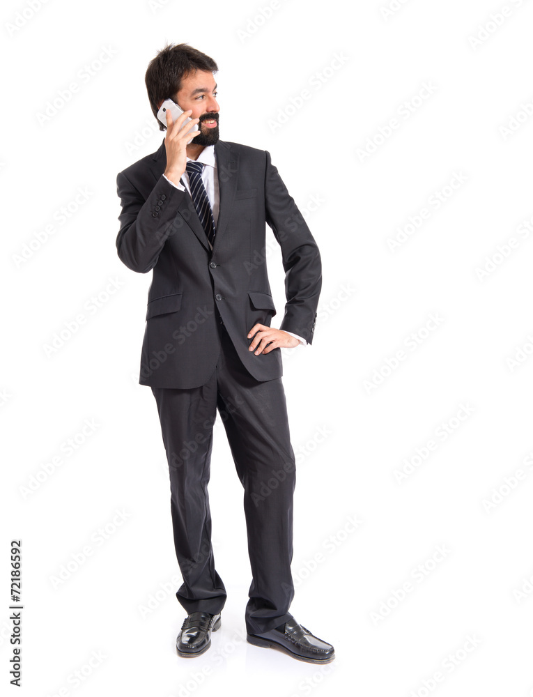 Businessman talking to mobile over white background Businessman talking to mobile over white background