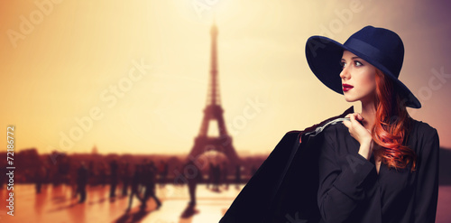 Photography Redhead women with shopping bags on parisian background.