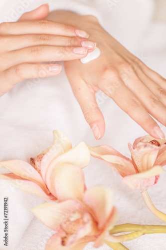 closeup of woman hands with white cream.