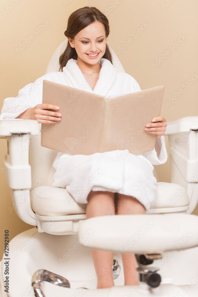 Young woman receiving pedicure in hairdressing salon. Young woman receiving pedicure in hairdressing salon.