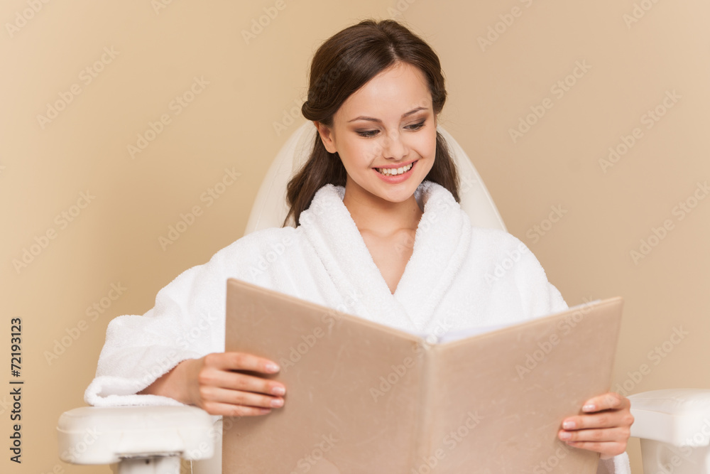 Young woman receiving pedicure in hairdressing salon. Young woman receiving pedicure in hairdressing salon.