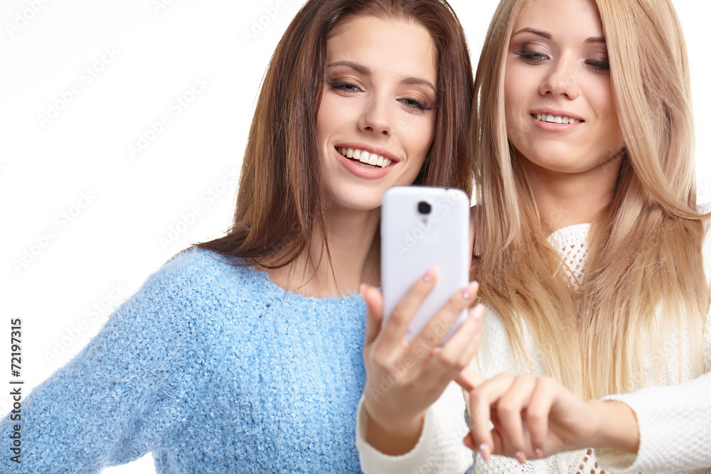 two beautiful girls making selfies at studio two beautiful girls making selfies at studio