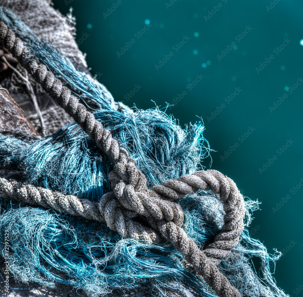 Tied rope on a fisherman net by the sea in hdr