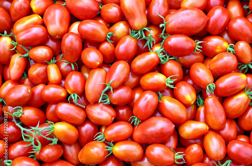 Background of the plurality of oval red tomatoes