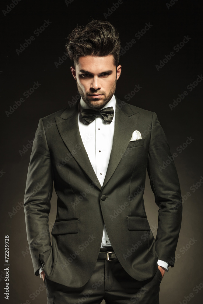 Handsome elegant business holding both hands in pockets. Handsome elegant business holding both hands in pockets.