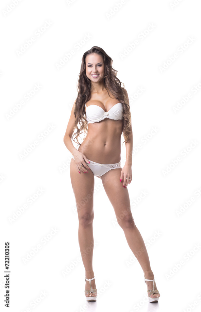 Smiling leggy girl posing in white erotic lingerie