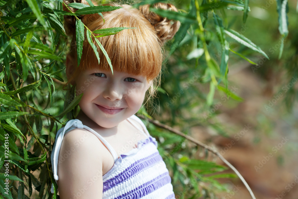Shy red-haired girl posing with tree Shy red-haired girl posing with tree