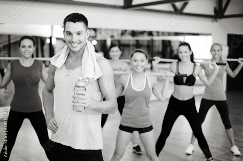 smiling trainer in front of group of people