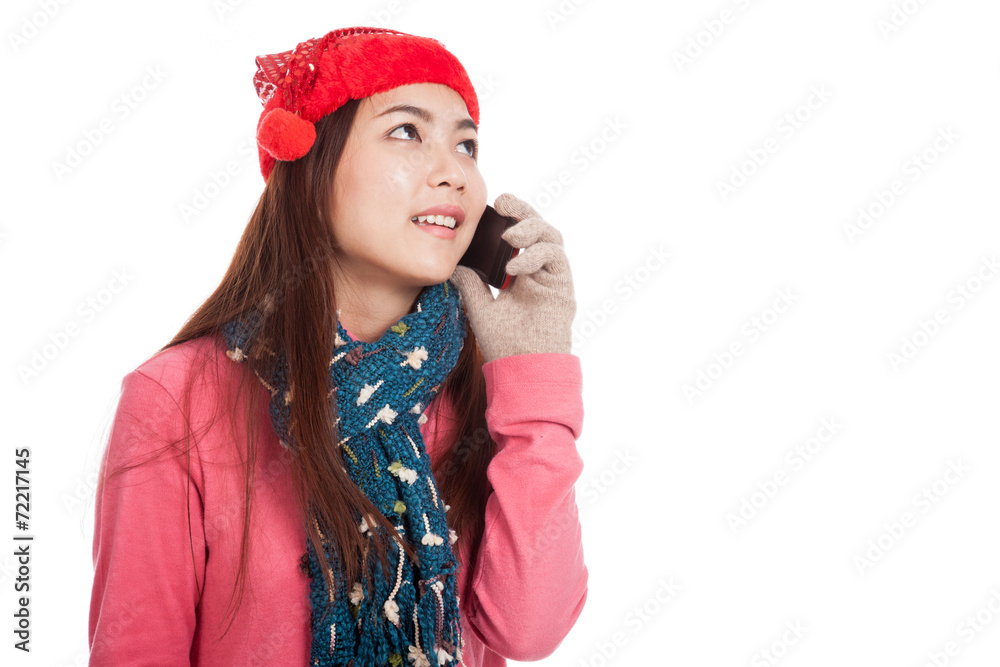 Asian girl with christmas hat look up talk on mobile phone Asian girl with christmas hat look up talk on mobile phone
