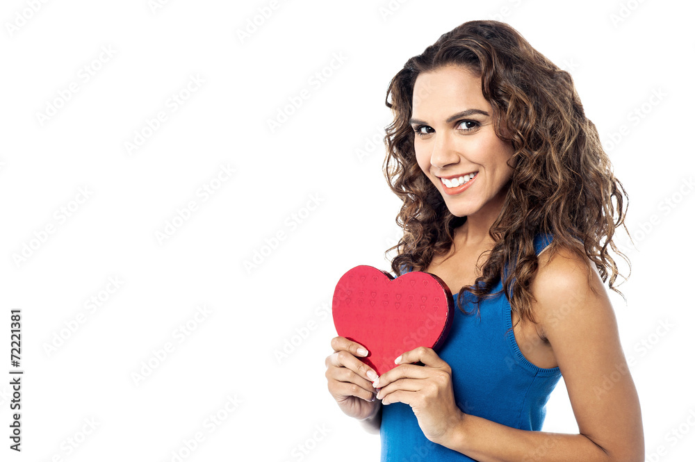 Young woman holding a red paper heart Young woman holding a red paper heart