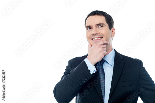Businessman thinking with hand on chin © stockyimages