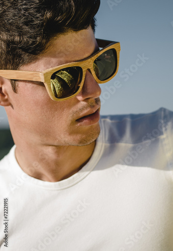Model man portrait with wooden sunglasses