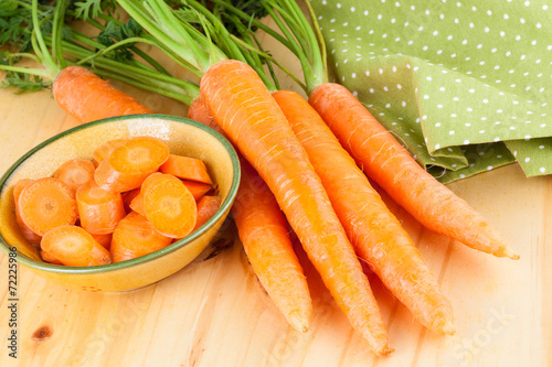 Fresh Carrots over wooden background