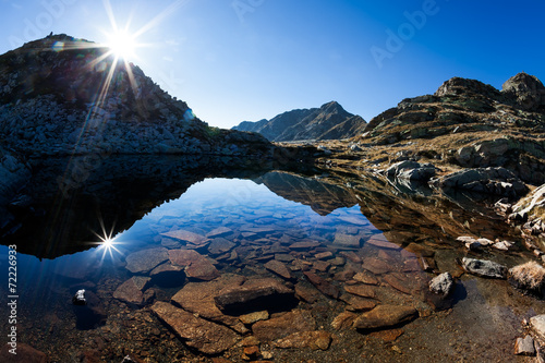 Small mountain lake in a sunny autumn day in italian Alps