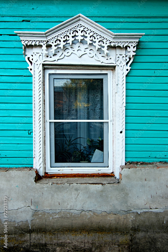Vintage wooden window painted in green color in Russia