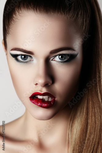  beautiful young woman with red lips and nails