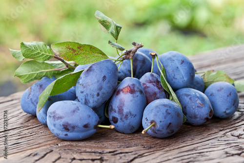 Plums on an old wooden table.