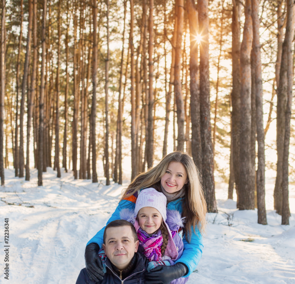 happy family in winter forest