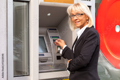 Bussines woman taking money from ATM