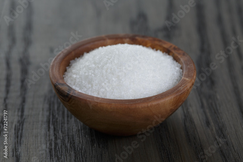 white sugar in wooden bowl for cooking or spa