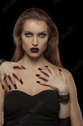 Gothic woman with hands of vampire on her body. Halloween