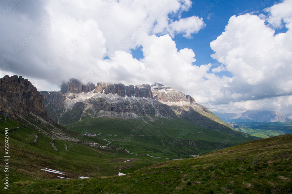 Sass Pordoi mount in blue sky with clouds, Dolomites