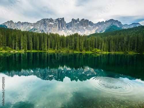 Latamar mountain and woods reflected in lake Carezza, Dolomites