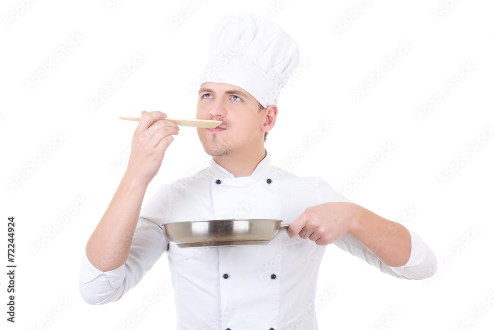 young man in chef uniform tasting something isolated on white young man in chef uniform tasting something isolated on white