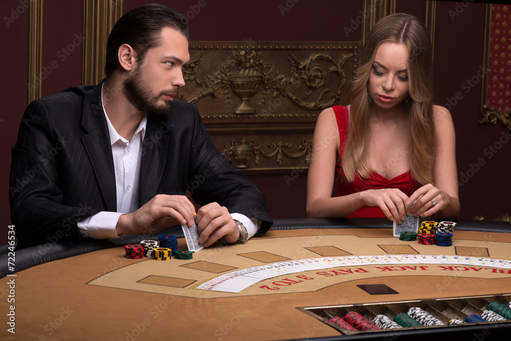 Fototapeta premium Handsome man and beautiful woman in casino