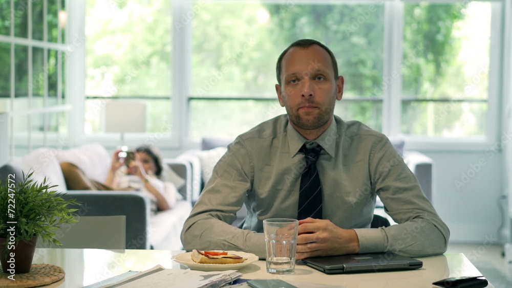 Gloomy businessman looking to the camera at home Gloomy businessman looking to the camera at home