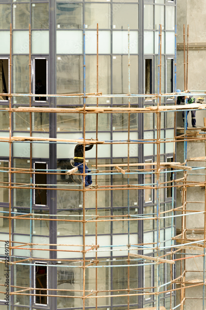 Construction workers on a scaffold in Baku, Azerbaijan Construction workers on a scaffold in Baku, Azerbaijan