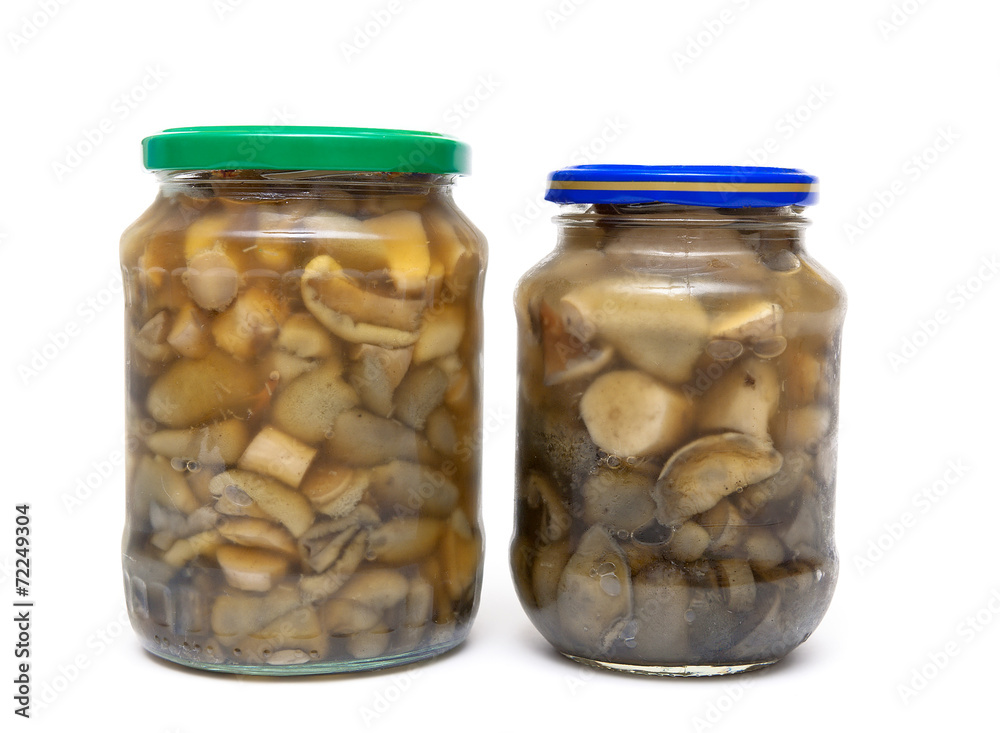 marinated mushrooms in the glass jars isolated on white backgrou marinated mushrooms in the glass jars isolated on white backgrou