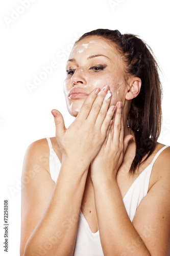 Photos young women applied cream for removing makeup on her face