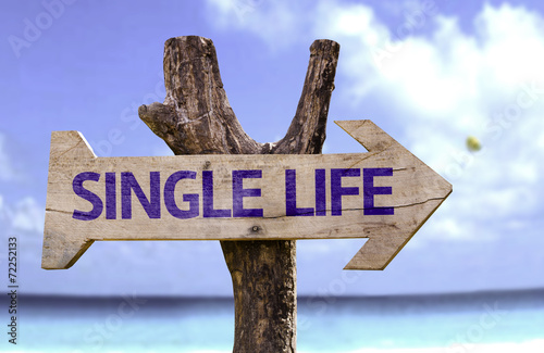 Single Life wooden sign with a beach on background photo