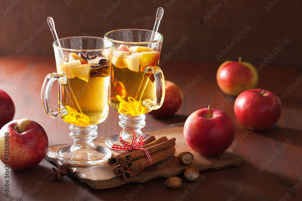 glass of mulled apple cider with orange and spices, winter drin glass of mulled apple cider with orange and spices, winter drin