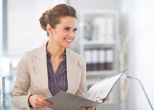 Fényképezés Happy business woman with documents in office