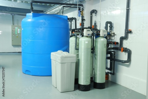 industry pipes, taps, pump and blue barrel